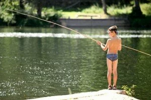 wild swimming boy fishing